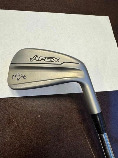 Callaway Apex golf iron club photographed on a table.