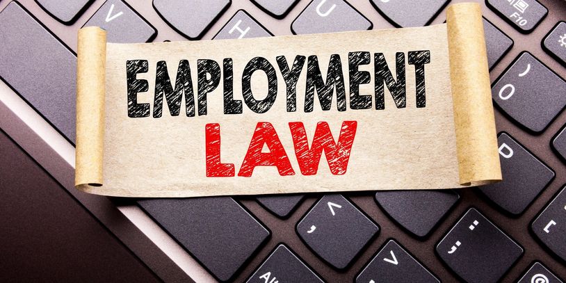 Scroll with 'Employment Law' on keyboard background.