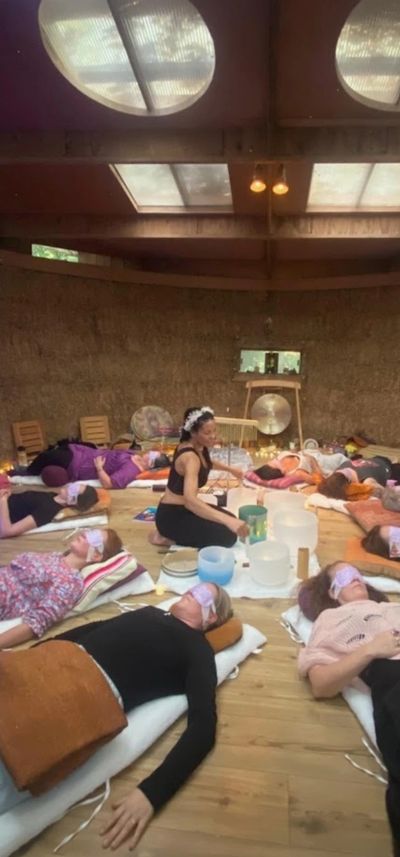 People in a group meditation or sound healing session indoors.