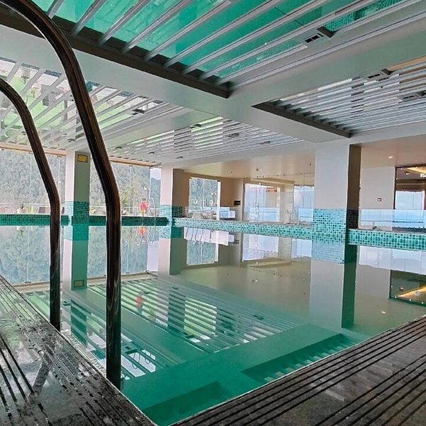 Indoor swimming pool with clear water and modern design.