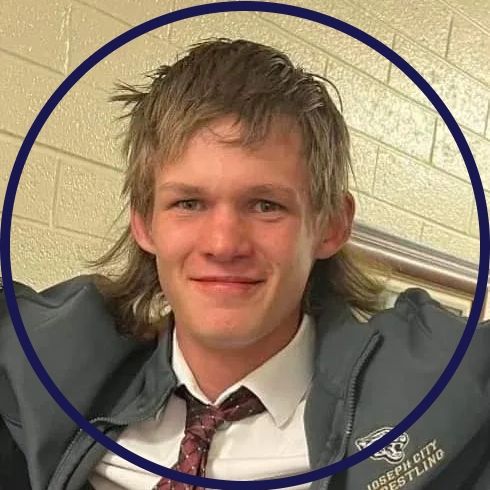 Young man with a casual hairstyle wearing a jacket and tie.