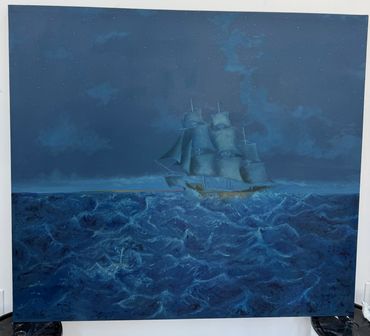 A sailing ship navigating rough seas under a dark, cloudy sky.