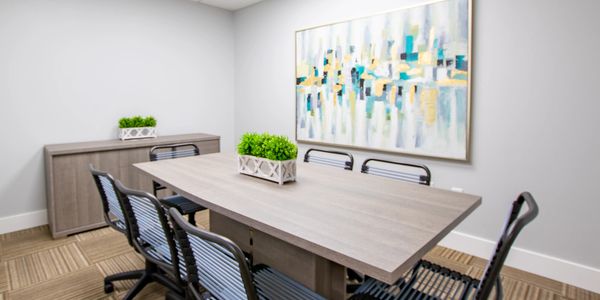 Psychology office with conference table and chairs.