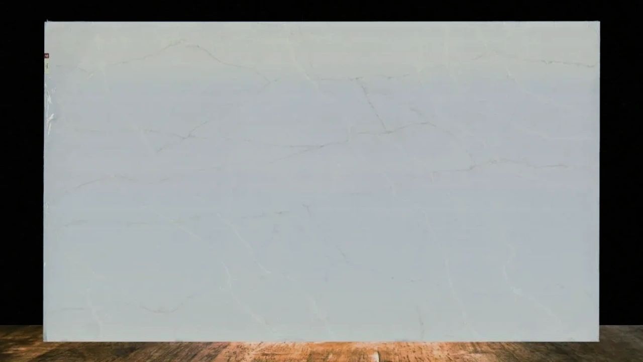 Large white marble slab with subtle beige veins displayed indoors.