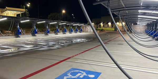 Empty electric vehicle charging station at night.