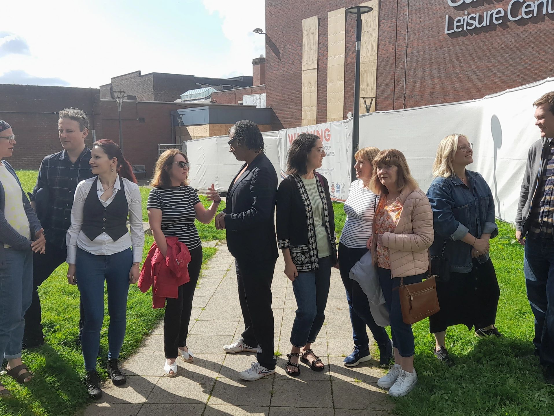 People stood together in a group outside a boarded up Gateshead leisure centre