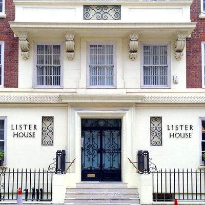 Elegant entrance of Lister House with black wrought iron doors and decorative elements.