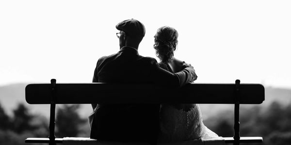 Married couple sitting on bench