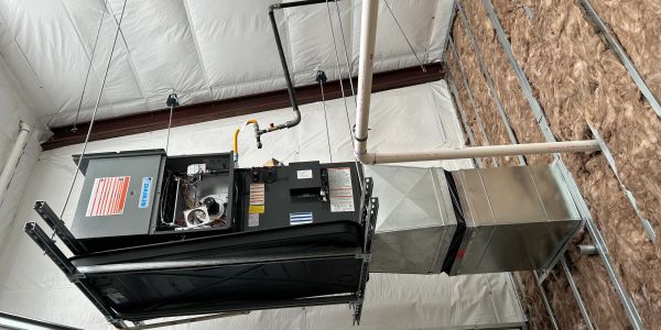 Ceiling-mounted HVAC unit in industrial space.