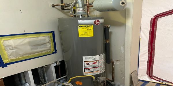 Hot water heater in a basement corner.