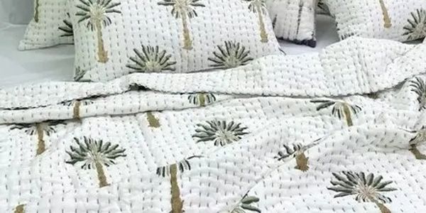White bedding with palm tree prints.
