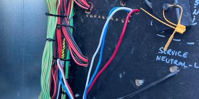 Electrical wiring panel with labeled wires.