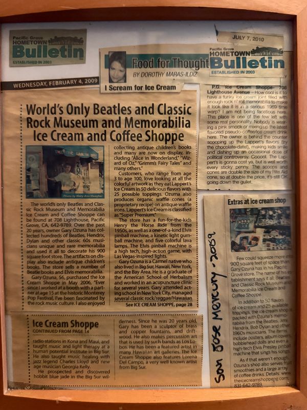 Framed newspaper article about the world's only Beatles and classic rock museum with ice cream and coffee shop.