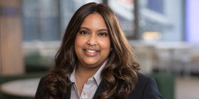 Professional woman with long hair smiling in a business setting.