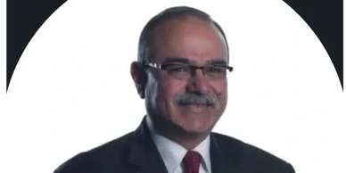 Professional man in glasses and suit with a mustache.