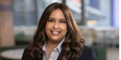 A professional woman smiling in a business setting.