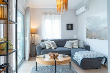 Cozy living room with gray sectional sofa and natural wood coffee table.
