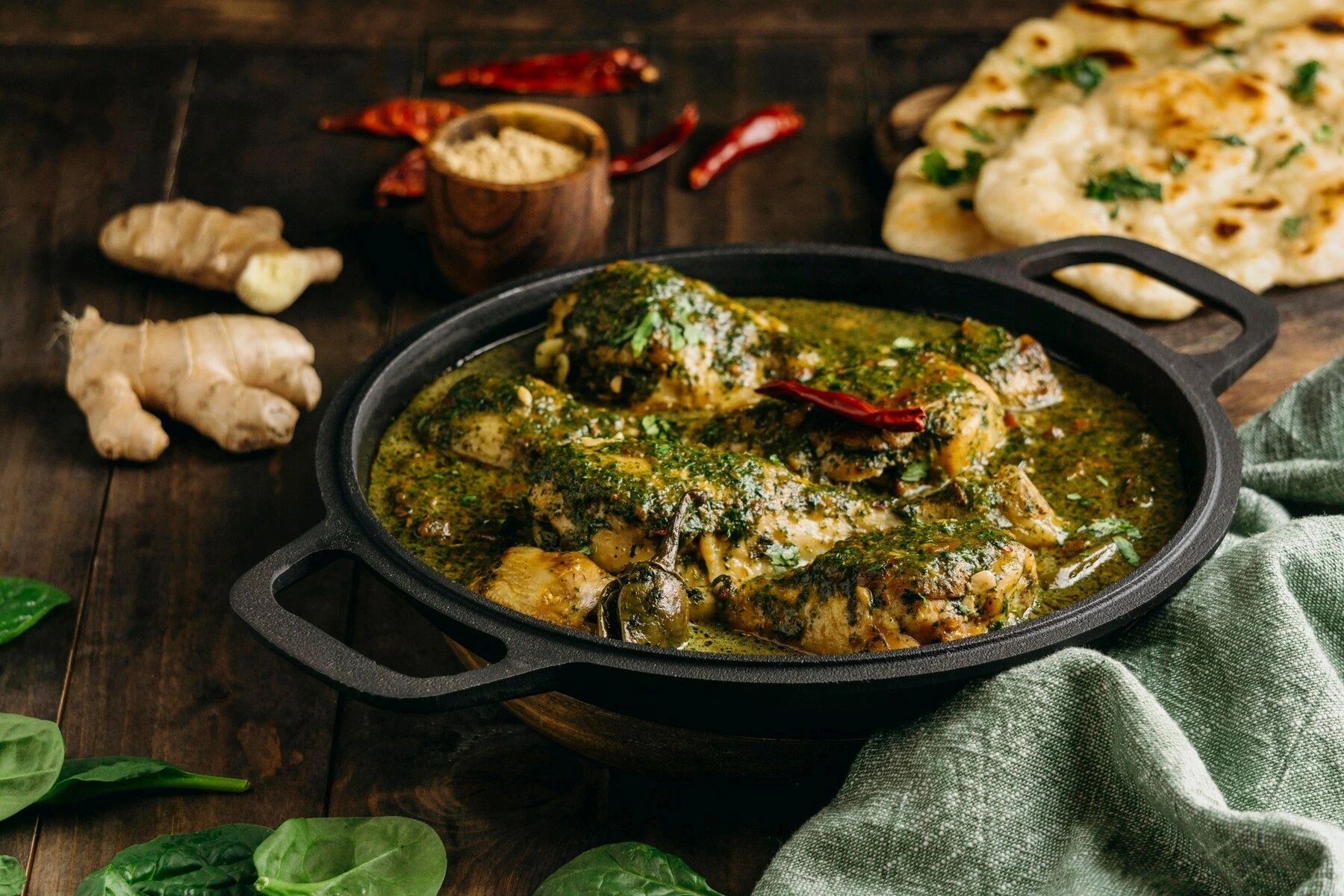 Rajasthani chicken pieces nestled in a luscious bed of fresh spinach.