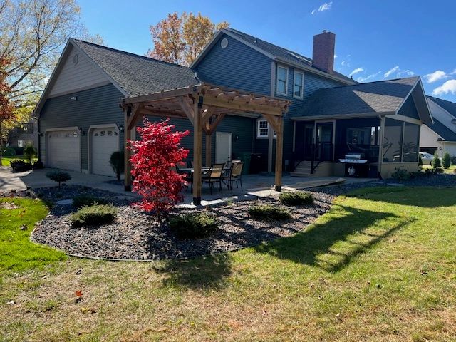 Completed two-story home with a covered porch and landscaped yard