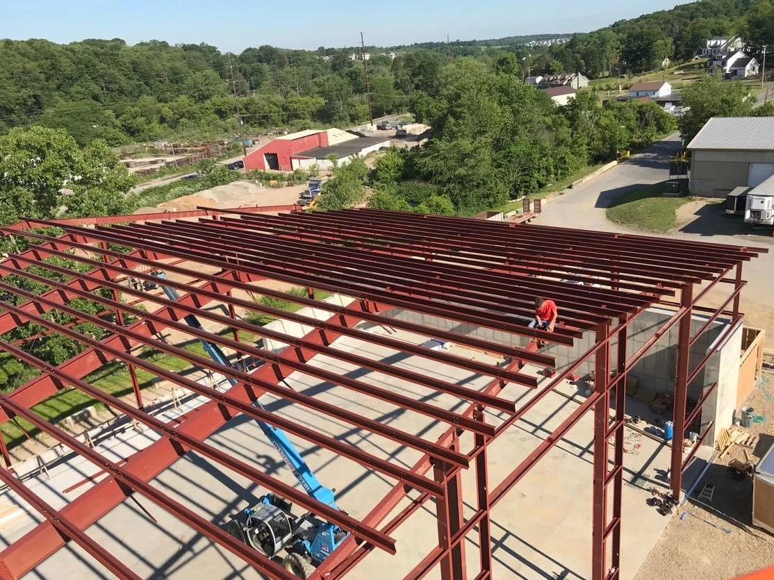 Commercial building under construction with exposed steel roof framing