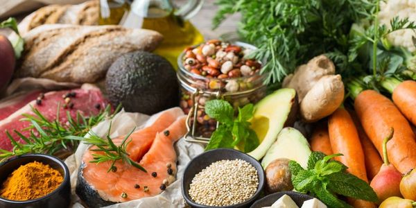 A colorful spread of fresh vegetables, salmon, and spices.