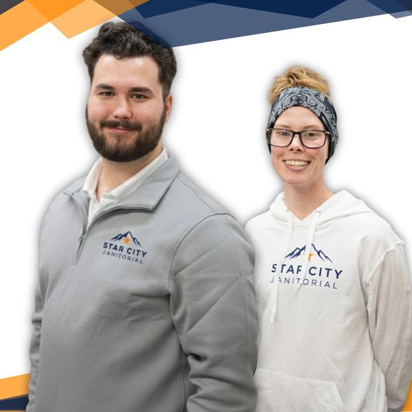 Two smiling employees in Star City Janitorial branded clothing against a white background.
