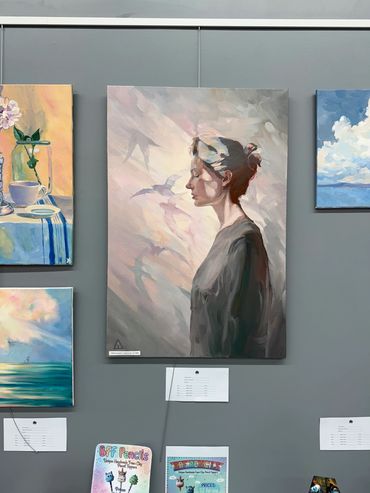 Painting of a woman with birds flying around her.