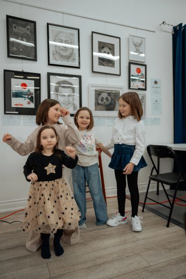 Four children posing in an art gallery.