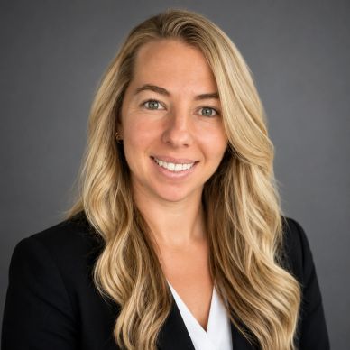 Professional woman with long blonde hair smiling.