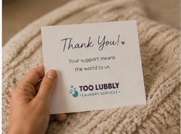 Hand holding a thank you card from Too Lubbly Laundry Services.