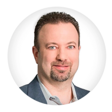 Professional headshot of a man with light eyes and a trimmed beard.