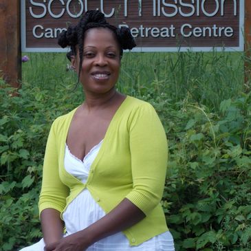 President Veronica smiling  sitting outside the Scott Mission