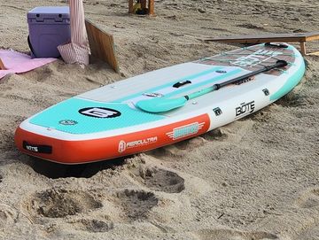 Luxury cabana setup with beach chairs and stand up paddleboard in Juno Beach. Beach chair rental.