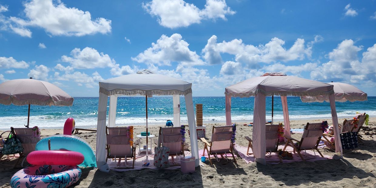 Fort Lauderdale beach cabana rental with umbrellas and beach chairs for a relaxing day.