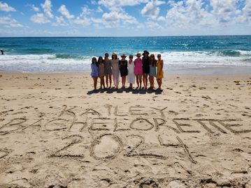 Fun Bachelorette Beach Day setup with cabanas, giant flamingo float, and beach games on Palm Beach