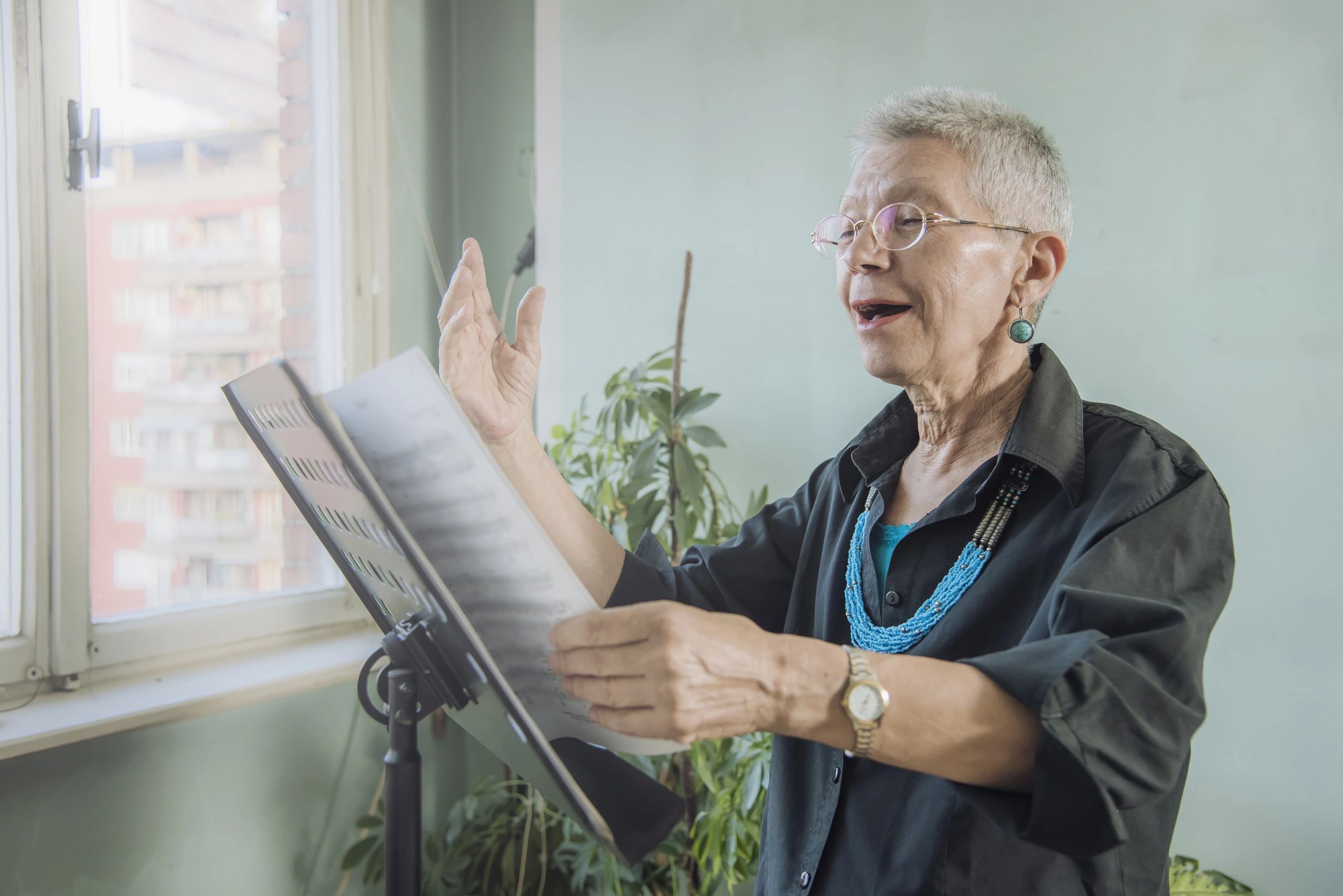 Older female adult reads sheet music at St Louis singing lessons