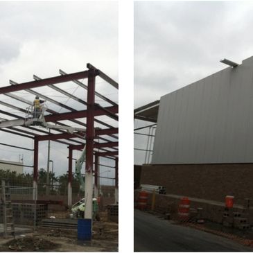 Construction site showing steel framework and wall panel installation.