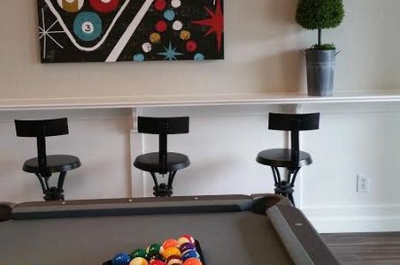 What WAS a normal "living room" is now a game room ready to host the best parties these clients have to offer! After a game of pool, guests can exit through the triple french doors to a beautiful back yard paradise.