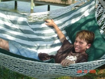 Young boy relaxing in Hammock