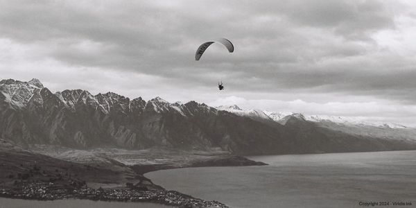 A paraglider flying over Queenstown, New Zealand