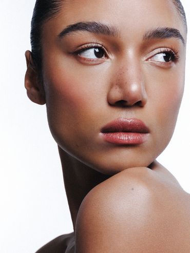Close-up portrait of a woman with smooth skin and natural makeup.