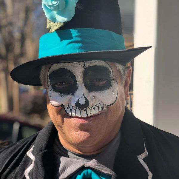 Adult male with skeleton face painting at Lanta Gras by Luz Cruz