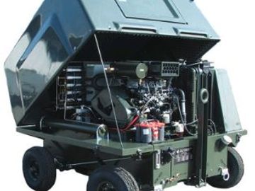 Military-grade mobile generator with open hood showing engine components.