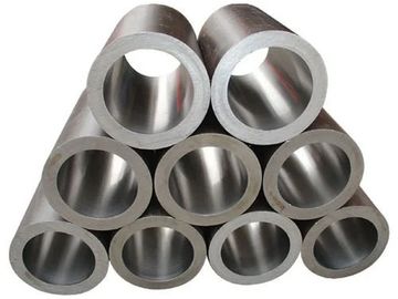 Stack of shiny metal hollow pipes arranged in a pyramid shape.
