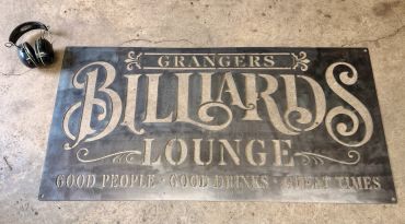 Vintage-style sign for Granger's Billiards Lounge on concrete floor.
