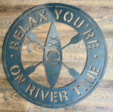 Metal sign with a kayak and paddles saying 'Relax you're on river time'.