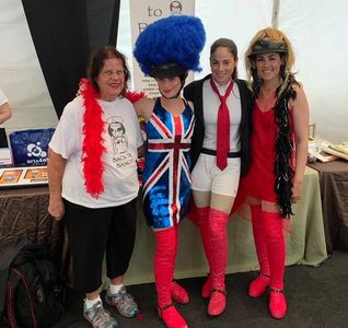 Four women posing together at an event.
