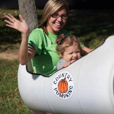 Mom and daughter riding in barrel train