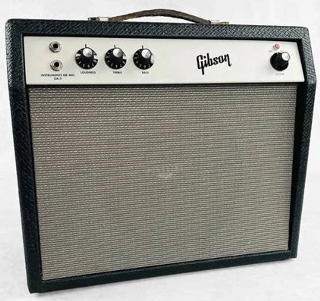 Vintage Gibson guitar amplifier with control knobs and a textured grille.