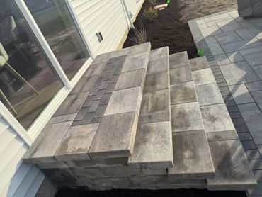 Newly constructed stone steps with a modern patio design.